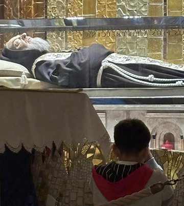 Little boy prays at tomb of St. Pio of Pietrelcina, Padre Pio 
